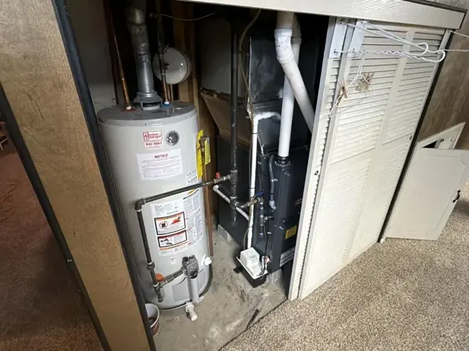 Water-stained closet around a leaking tank water heater